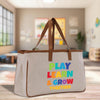 a canvas bag with play learn and grow written on it