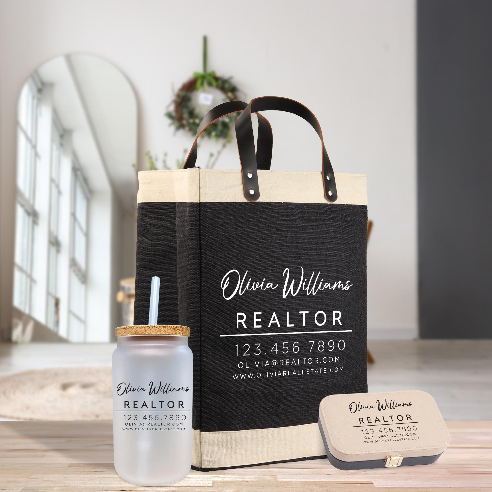 a black and white tote bag with the text &quot;Olivia Williams REALTOR&quot; printed on it, along with a matching black and white jar with a straw and a black and white tin box.