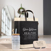 a black and white tote bag with the text "Olivia Williams REALTOR" printed on it, along with a matching black and white jar with a straw and a black and white tin box.