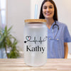 a woman standing next to a jar with a straw in it