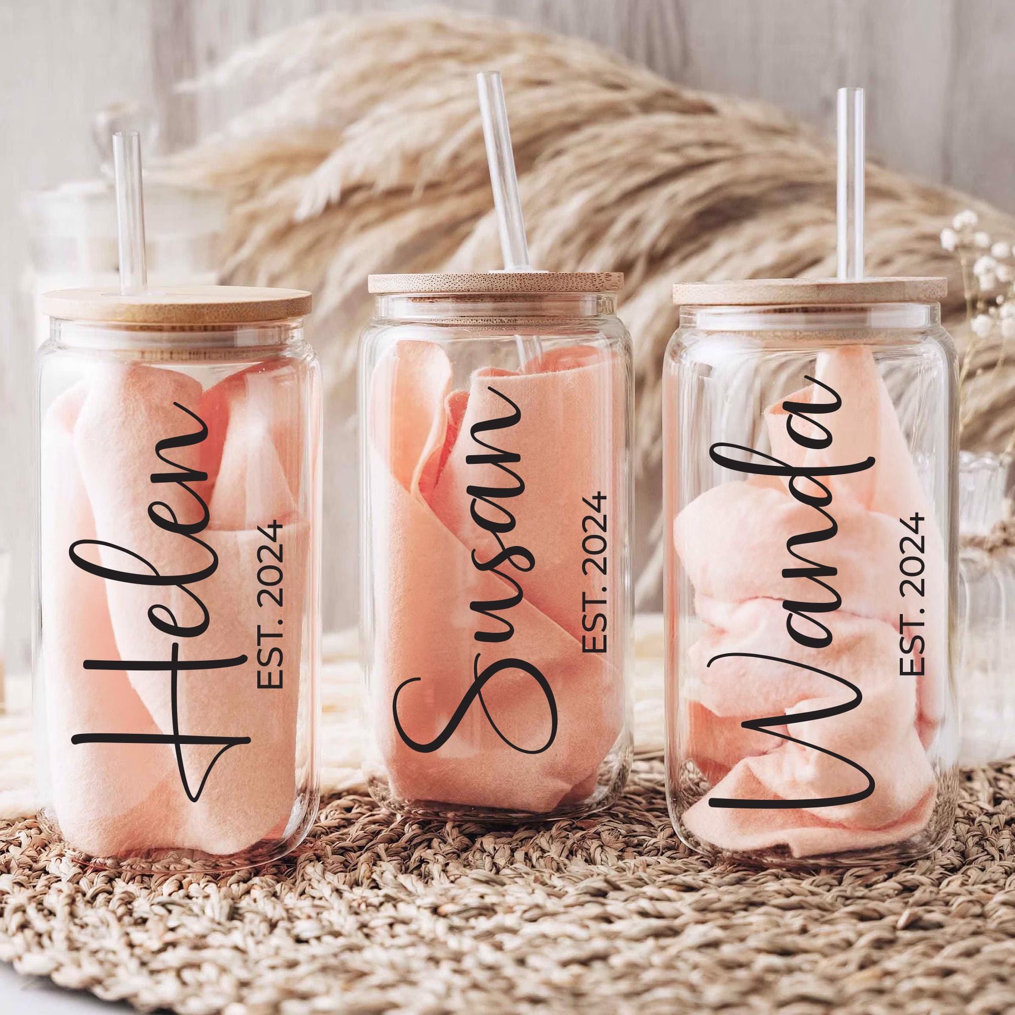 three personalized mason jars with straws in them