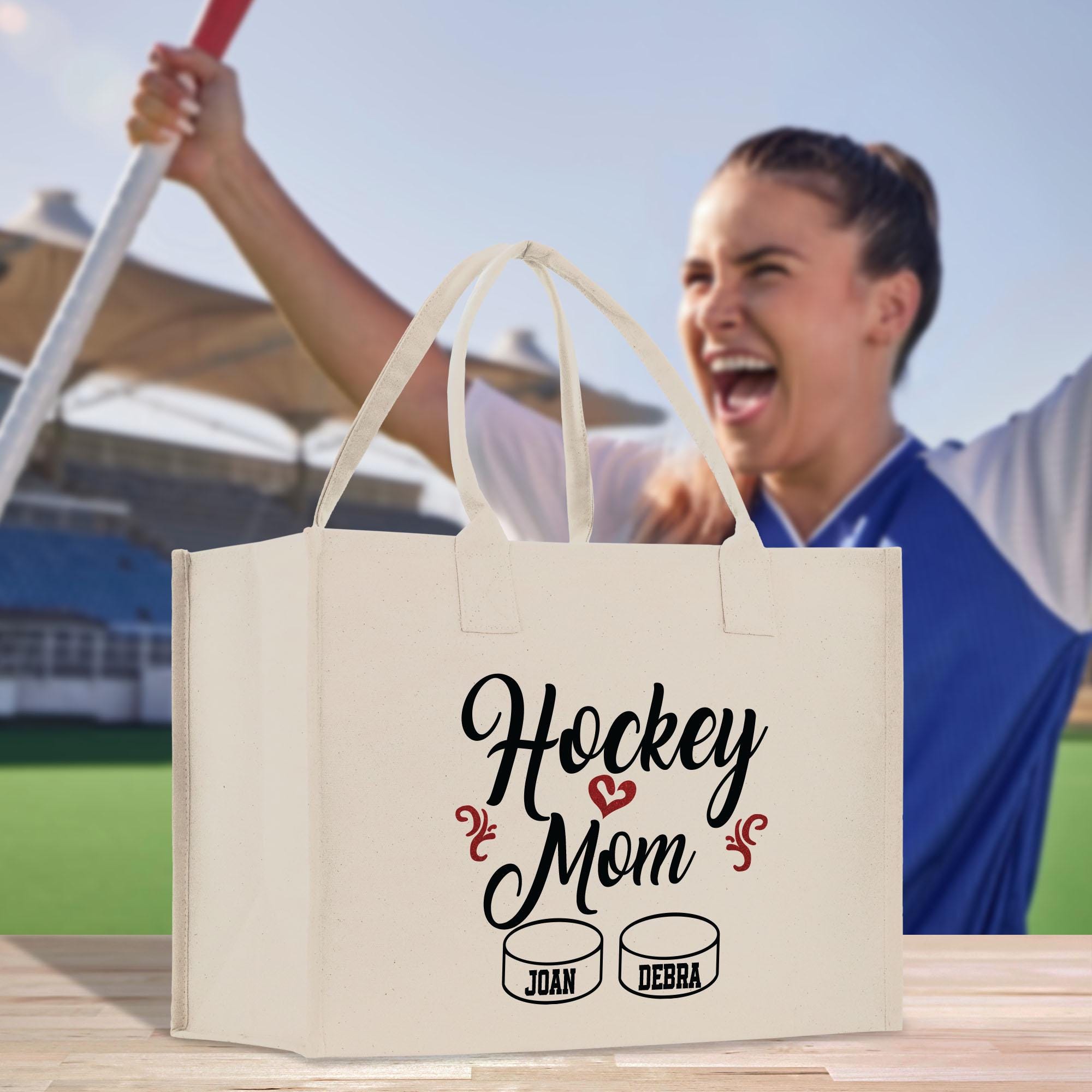 a man is holding a hockey mom bag