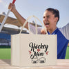 a man is holding a hockey mom bag