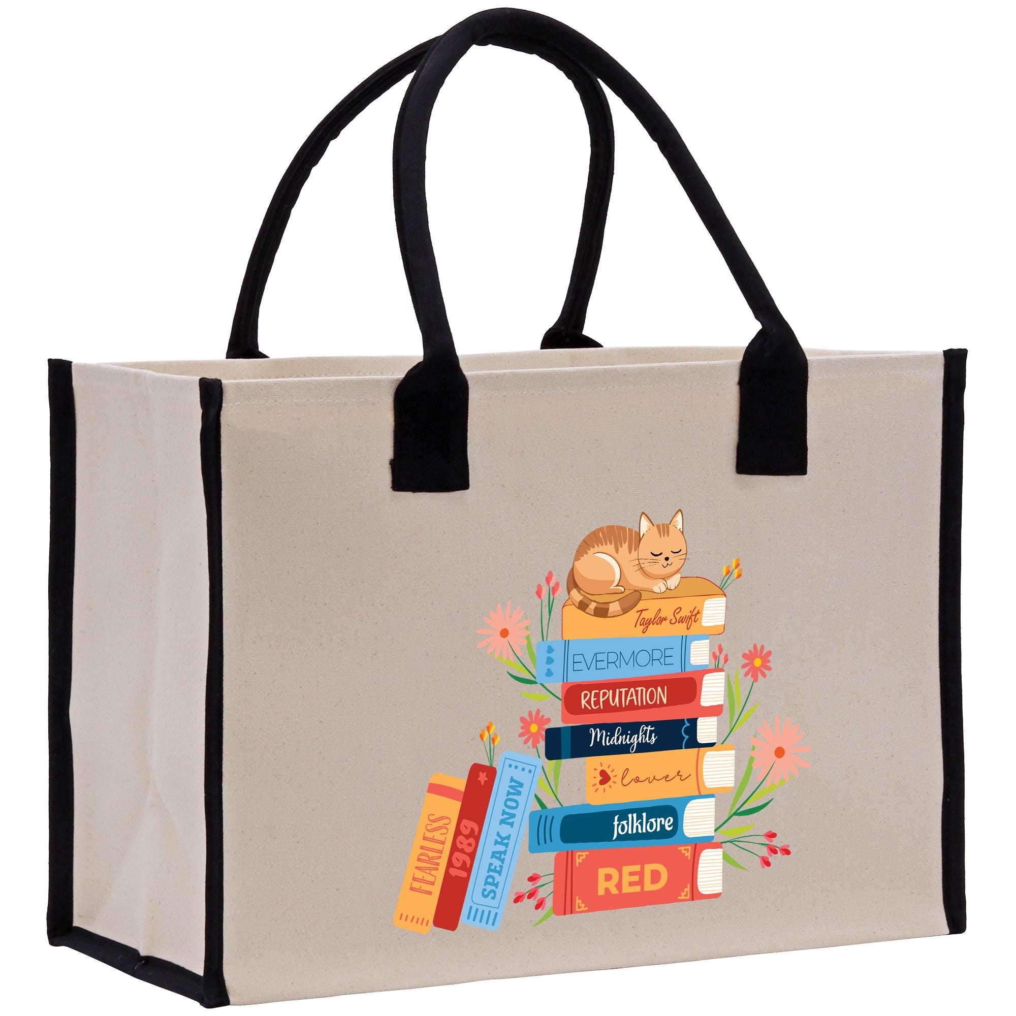A beige tote bag with a printed design of a stack of colorful books and a cat on top.