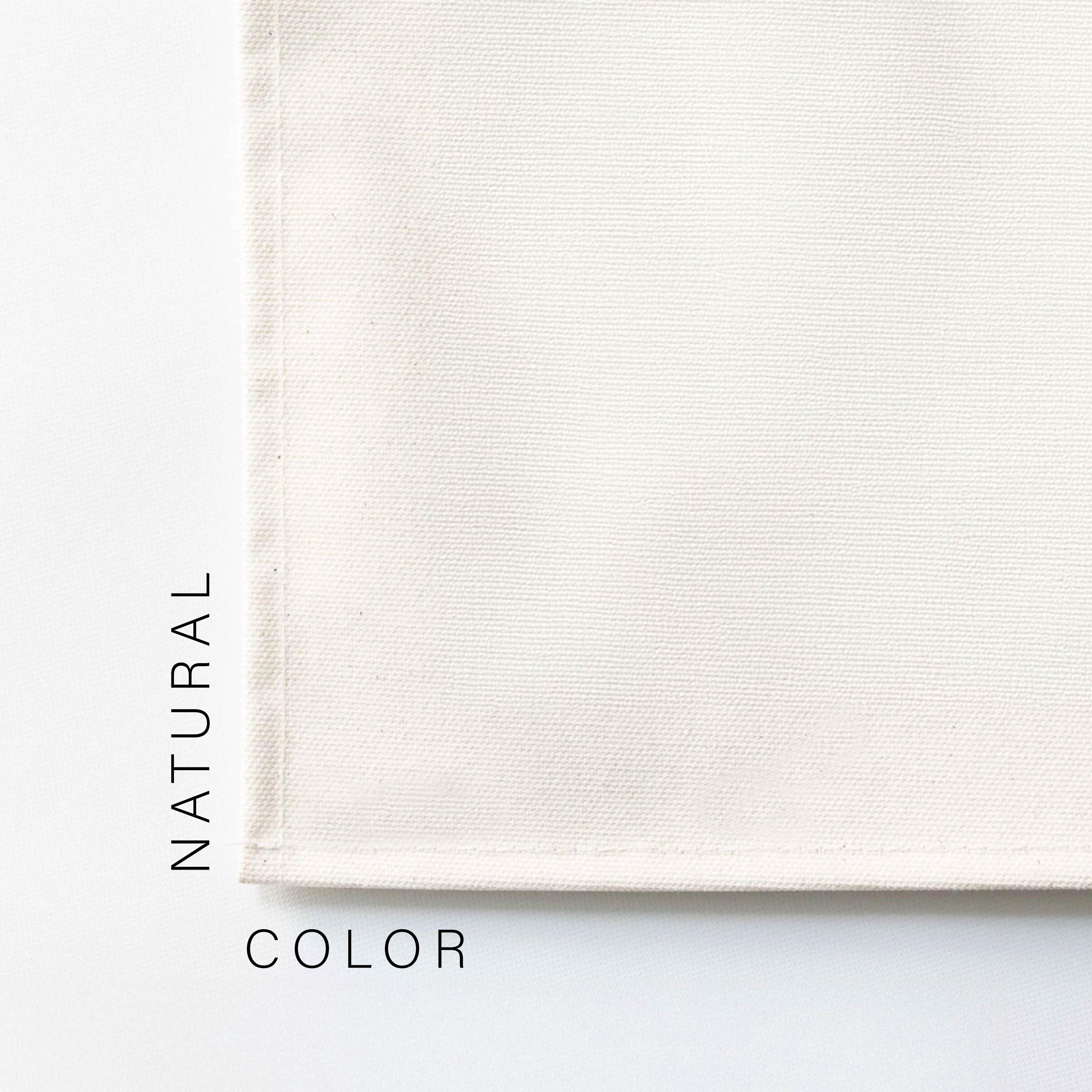 A close-up of a white fabric, possibly a piece of clothing or a textile, with the text &quot;NATURAL COLOR&quot; written next to it.