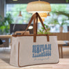 A beige canvas tote bag with the text "HUMAN RESOURCES Margaret" printed on it, placed on a wooden surface.