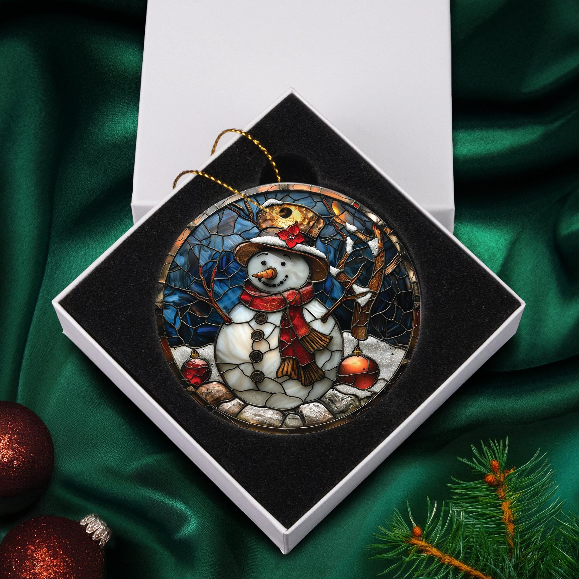 A snowman ornament in a white box, surrounded by Christmas decorations and greenery.