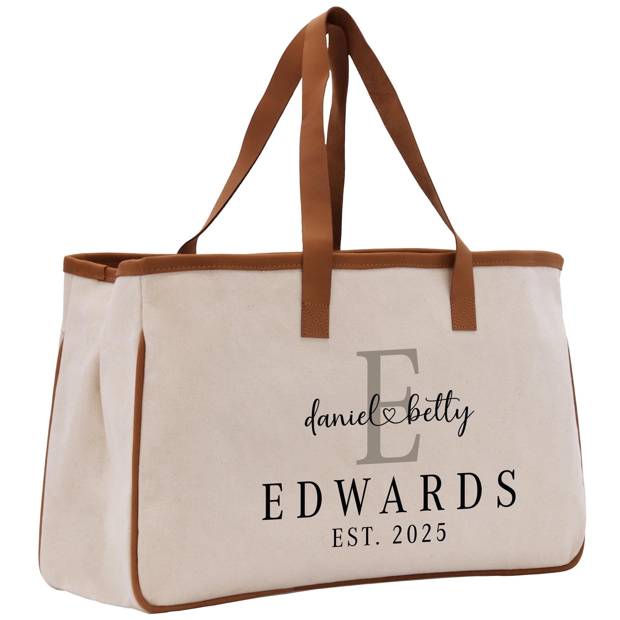 a white bag with brown handles and a brown strap