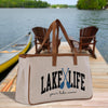 a lake life tote bag sitting on a dock