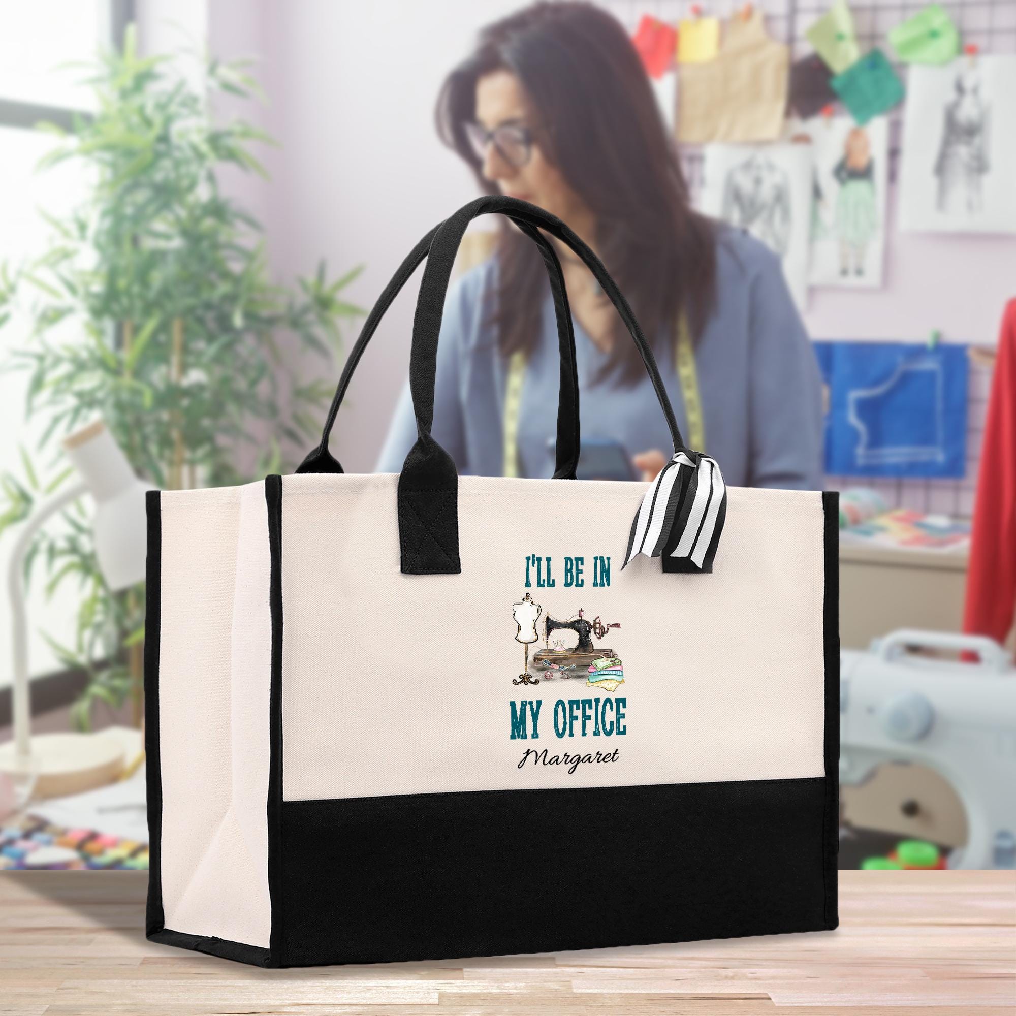 a woman standing behind a white and black bag