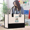 a woman standing behind a white and black bag