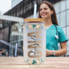 a woman standing in front of a glass with a straw in it