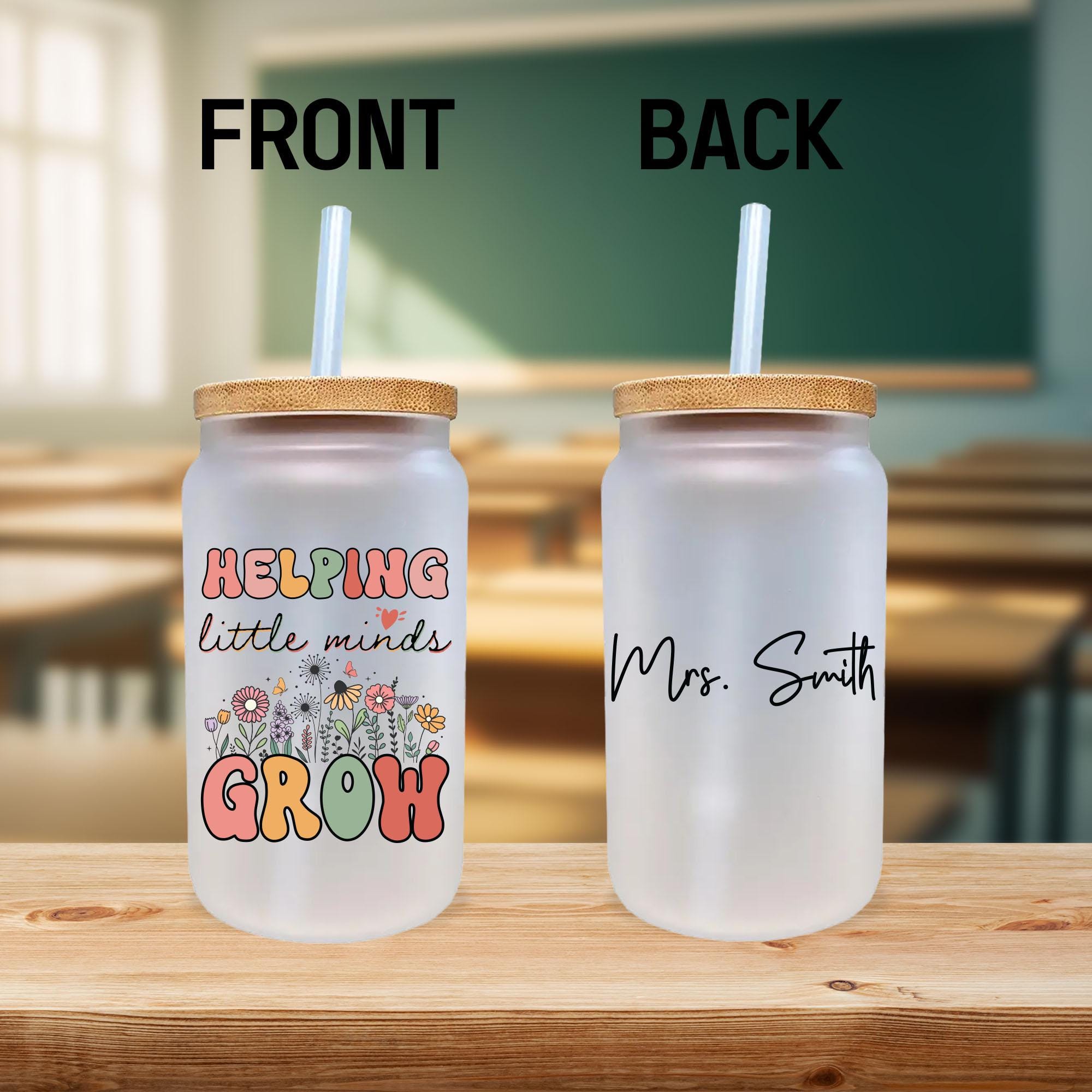 two plastic cups with straws sitting on a table
