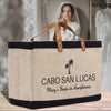 a woman in a white dress is holding a black and tan bag