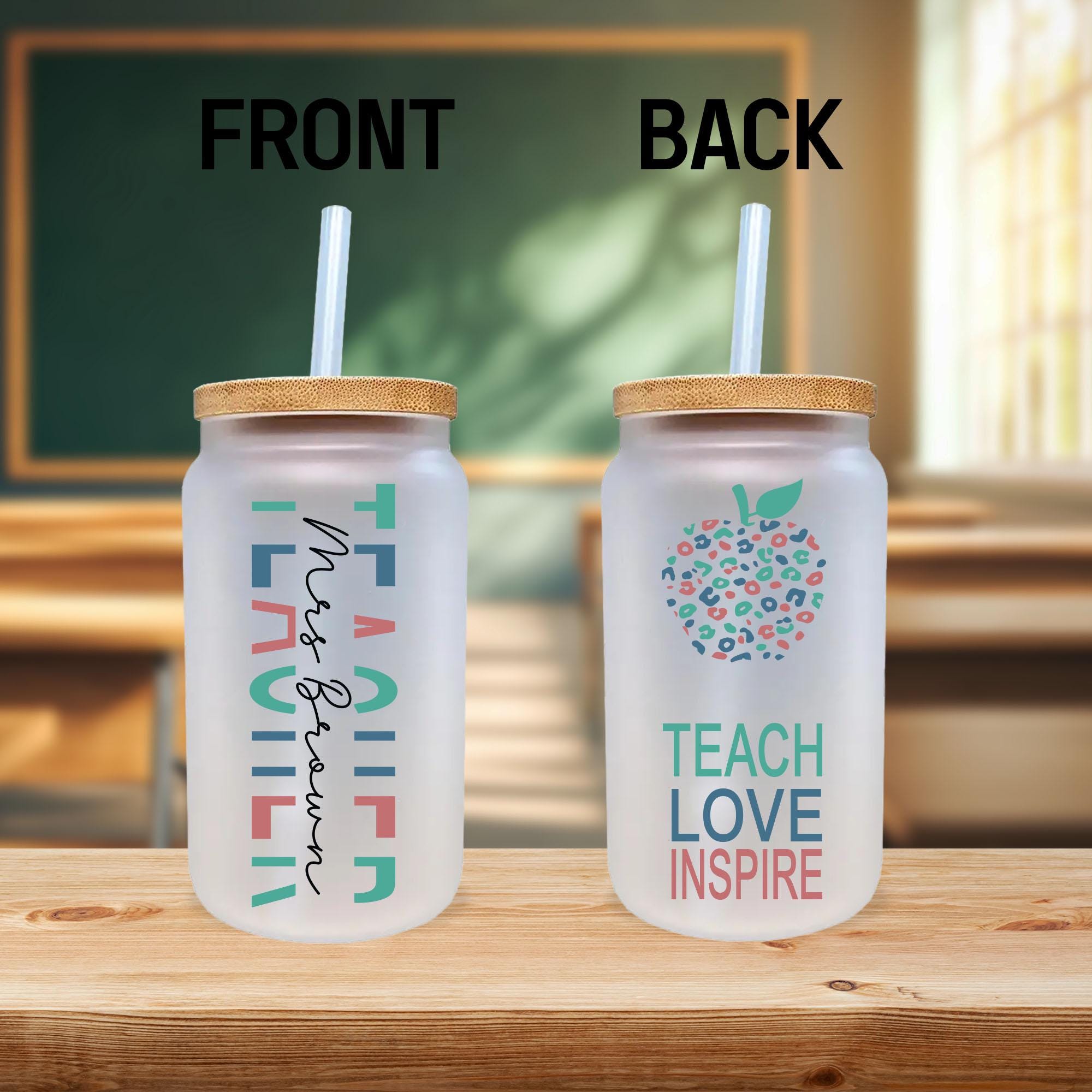 two plastic cups with straws sitting on a table