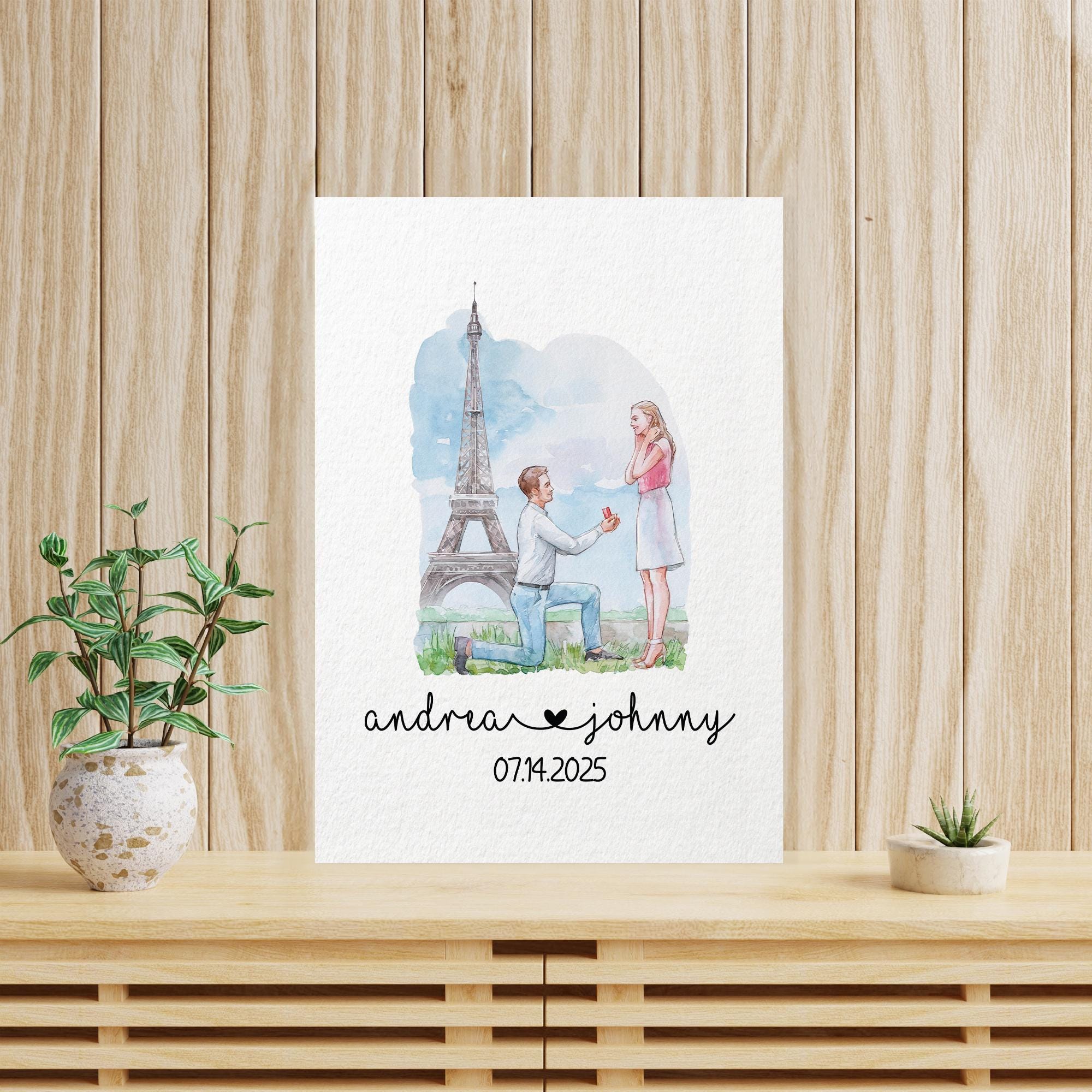 A white card with a romantic scene of a man kneeling and a woman standing in front of the Eiffel Tower, with the text &quot;andrew johnny 07/14/2025&quot; below the image.