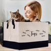 a woman holding a cat inside of a shopping bag