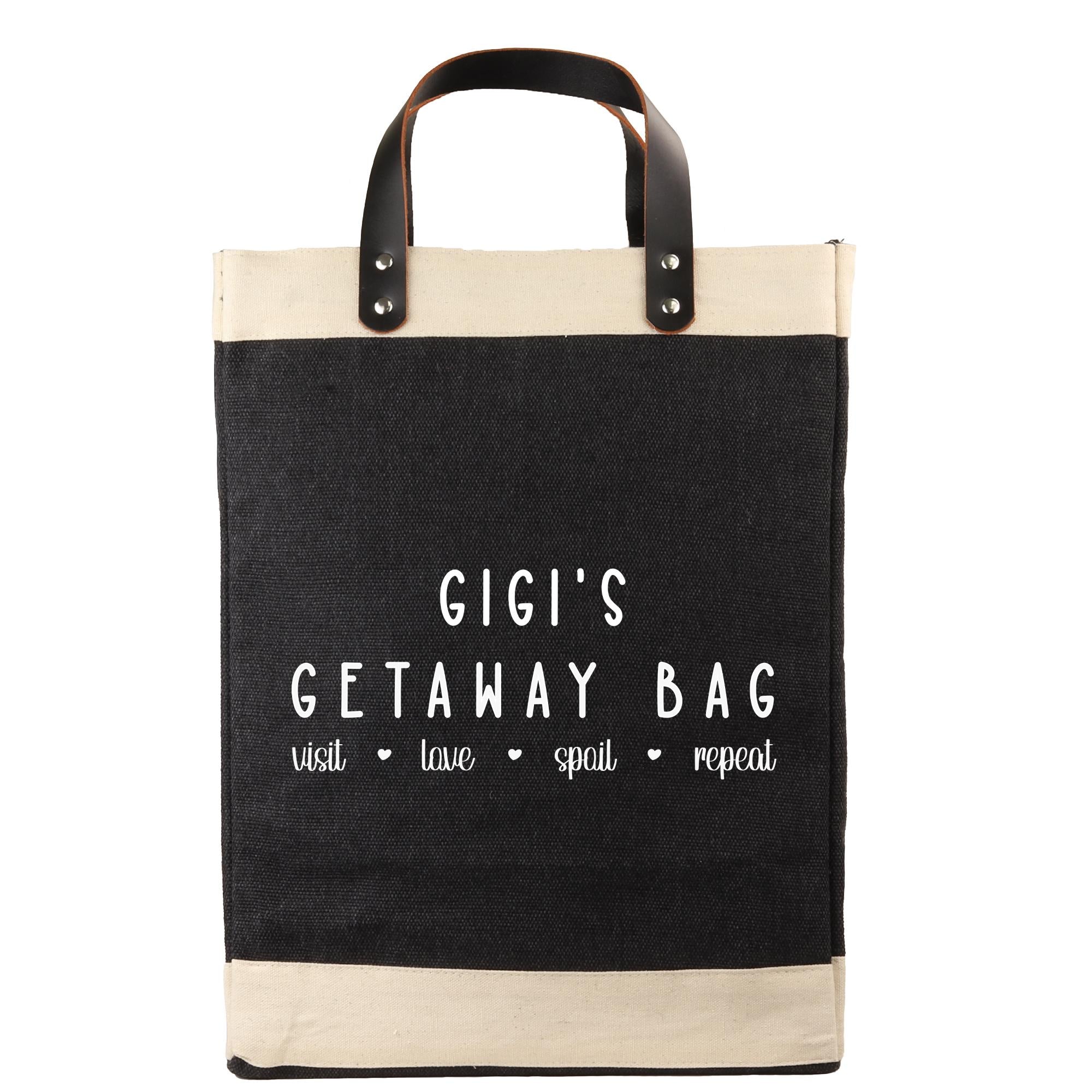 a black and beige tote bag with the text "GIGI'S GETAWAY BAG" printed on it.