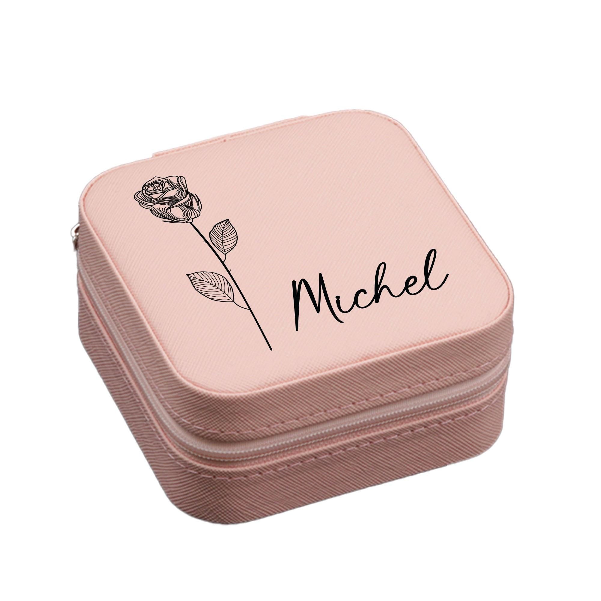 a pink lunch box with a rose on it