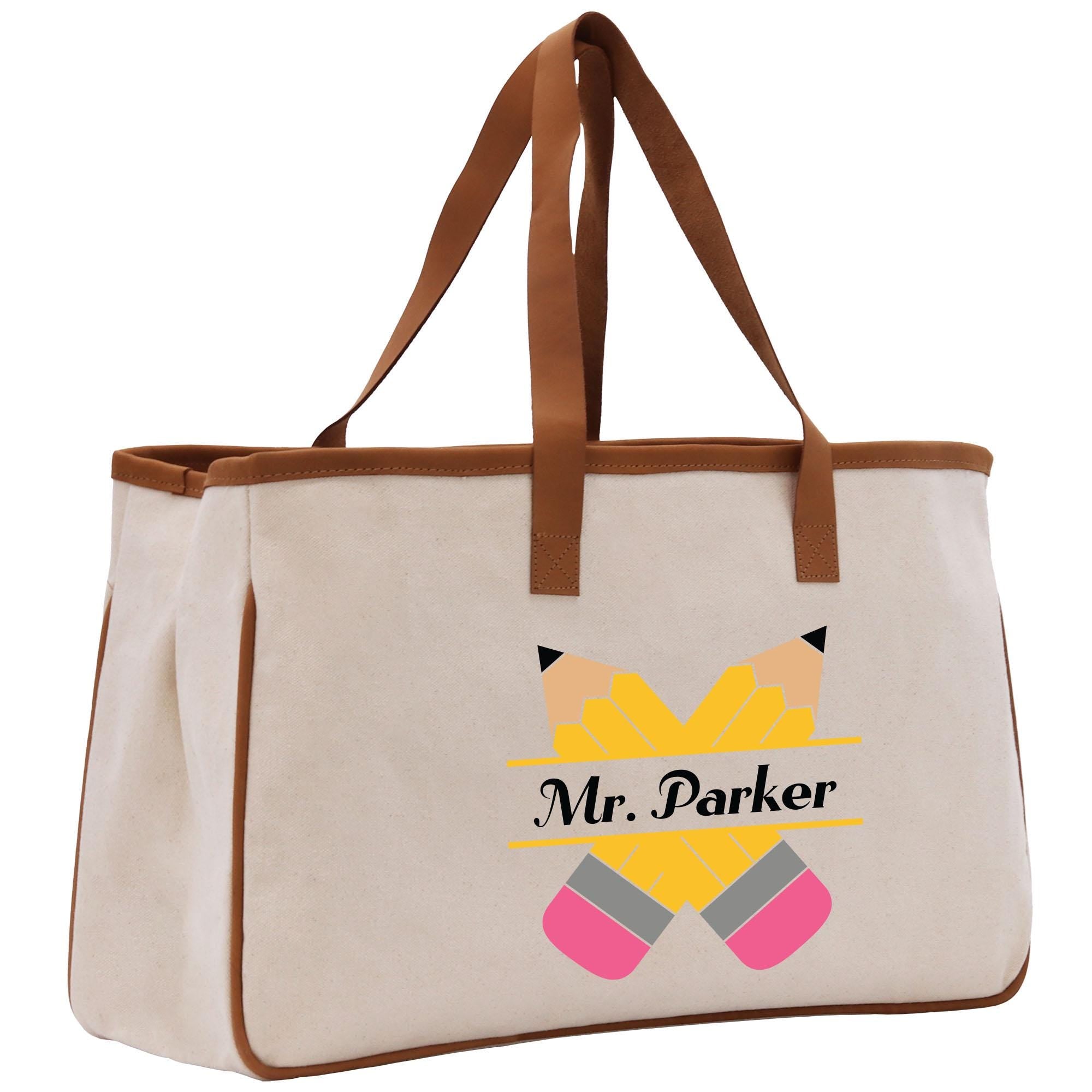 a white bag with a brown leather handle