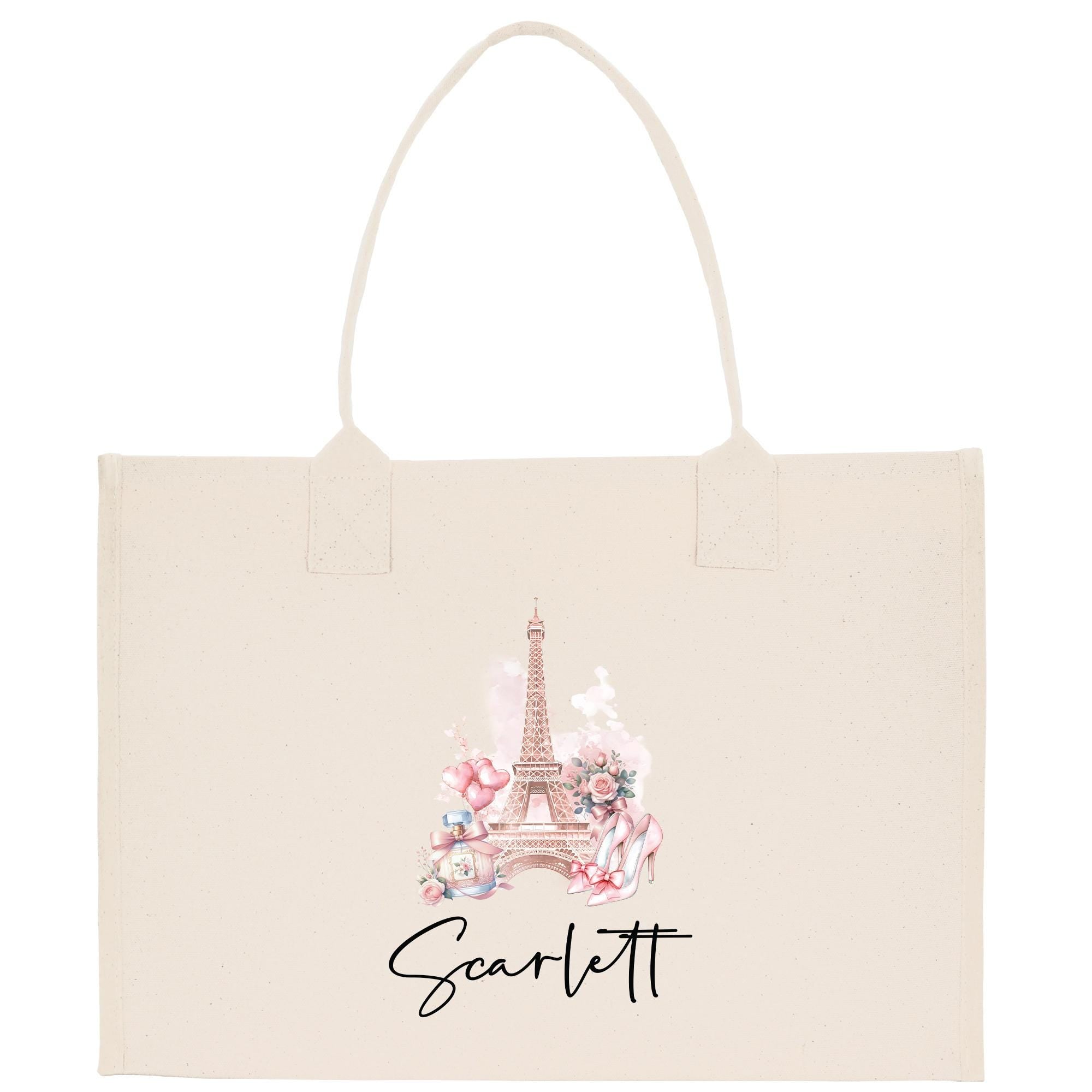A beige tote bag with a printed image of the Eiffel Tower and pink flowers.