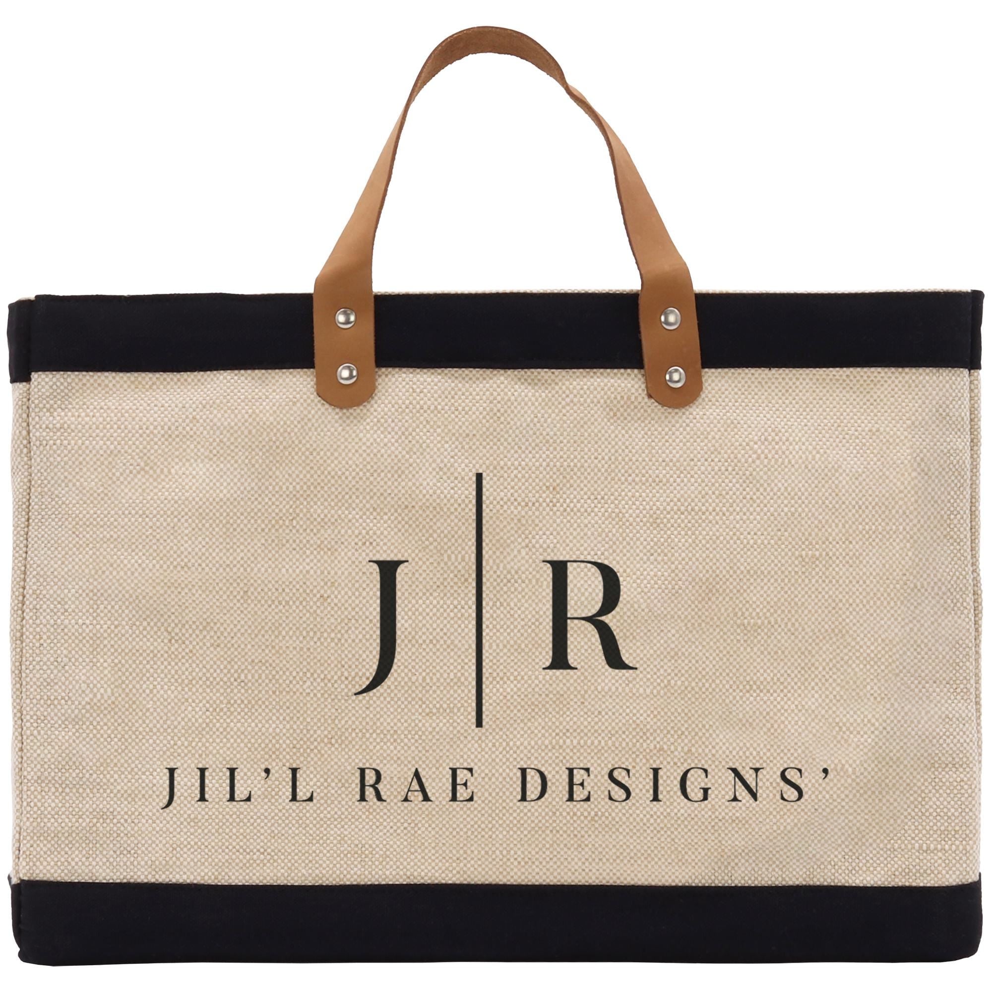 A beige tote bag with a black trim and leather handles, featuring the text &quot;Jil&#39;l Rae Designs&quot; printed on it.