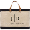 A beige tote bag with a black trim and leather handles, featuring the text "Jil'l Rae Designs" printed on it.