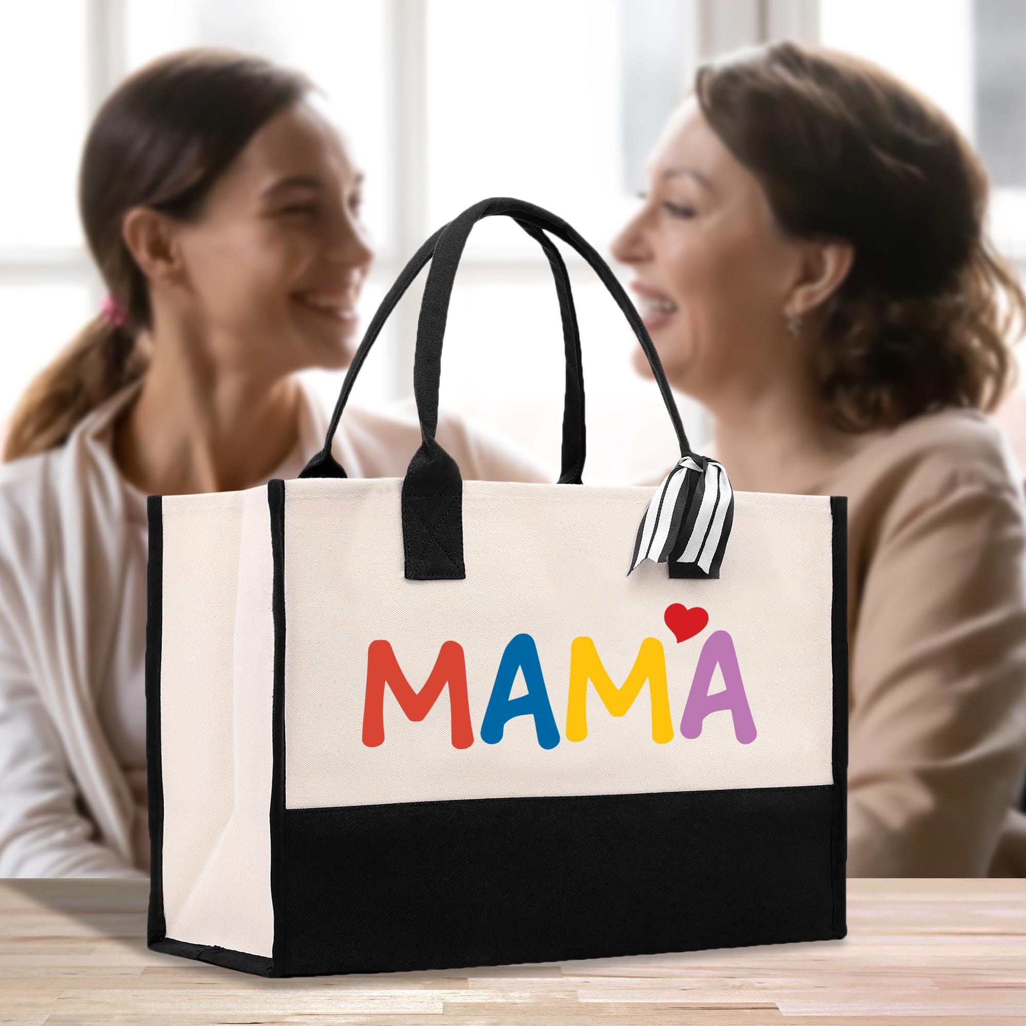 two women sitting at a table with a bag