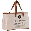 a white canvas bag with a brown leather handle