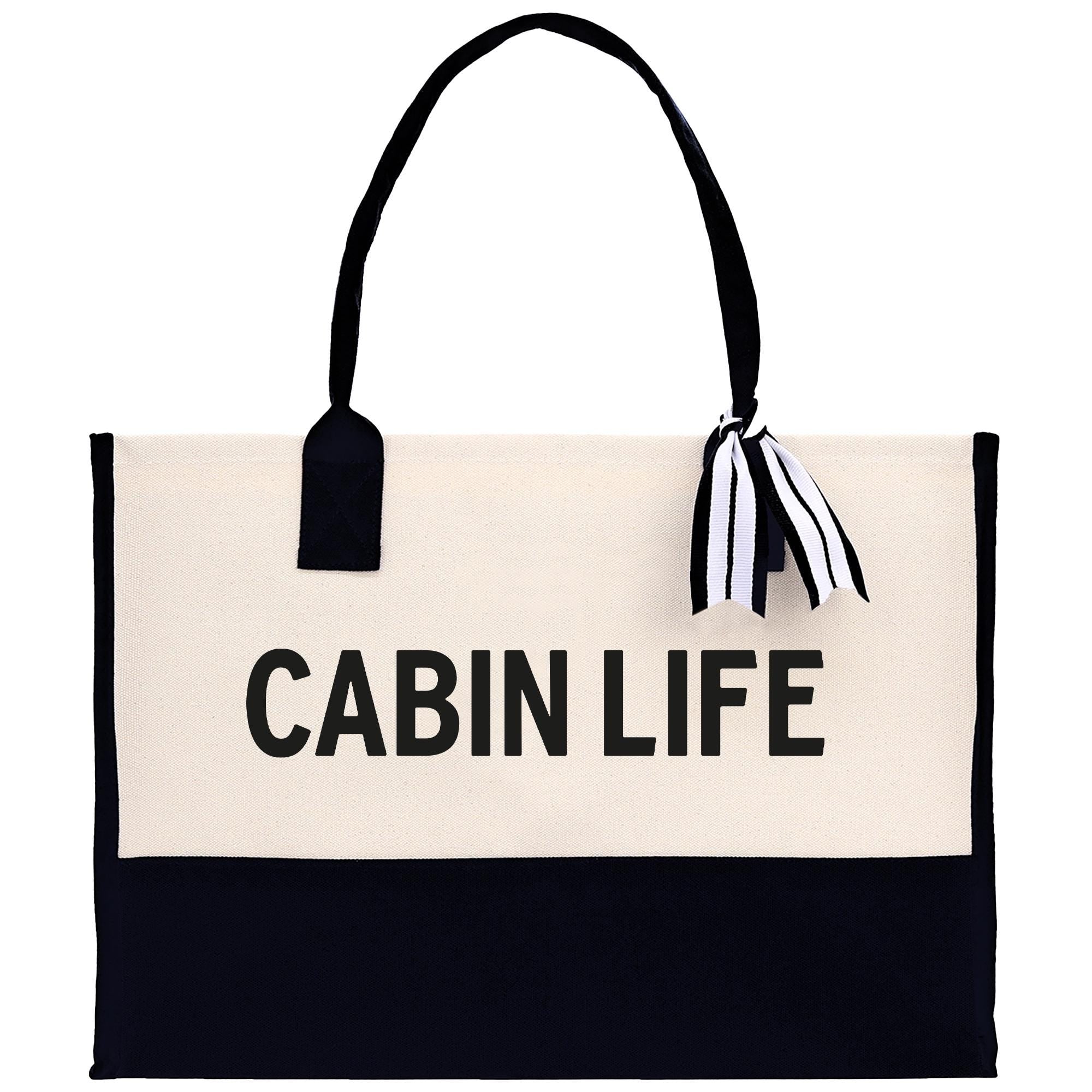 A black and white tote bag with the text "CABIN LIFE" printed on it.