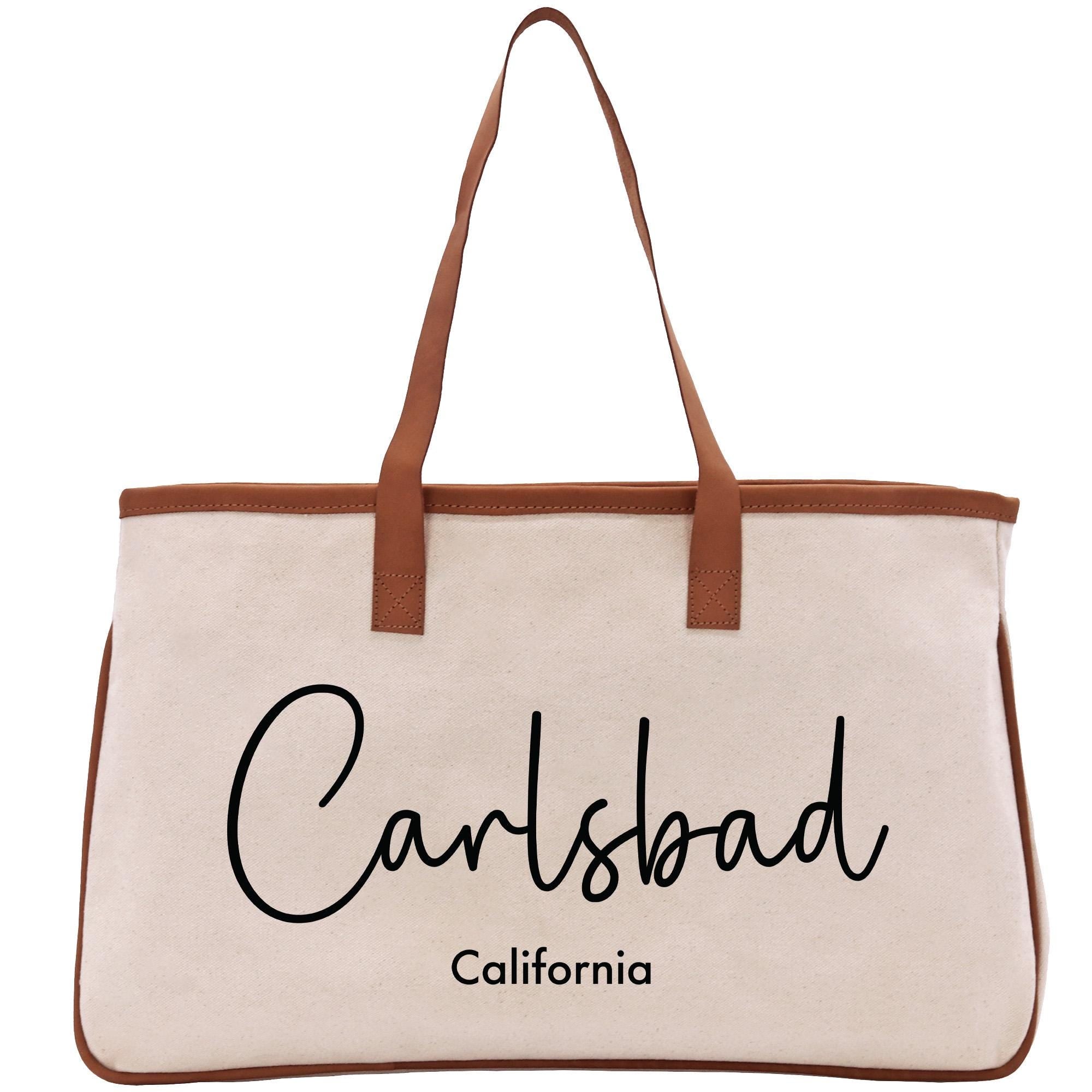 A beige tote bag with the text &quot;Carlsbad, California&quot; printed on it.