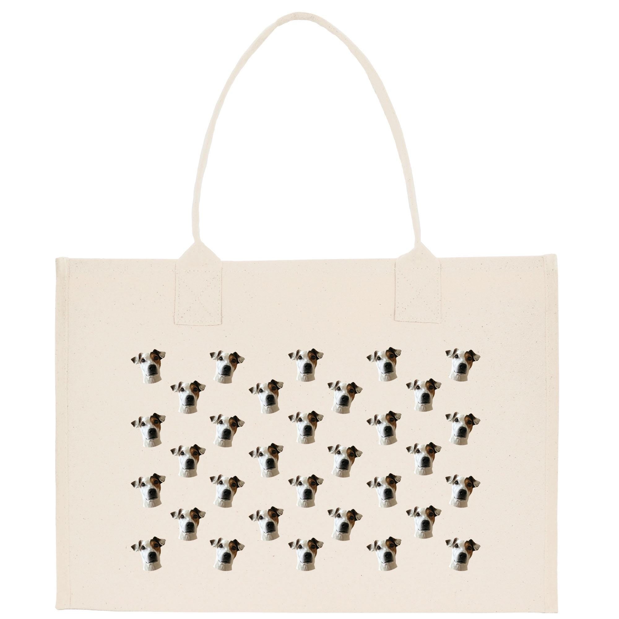 a beige tote bag with a repeating pattern of dog faces printed on it.