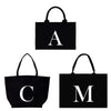 a tote bag with the letter a and a tote bag with the letter