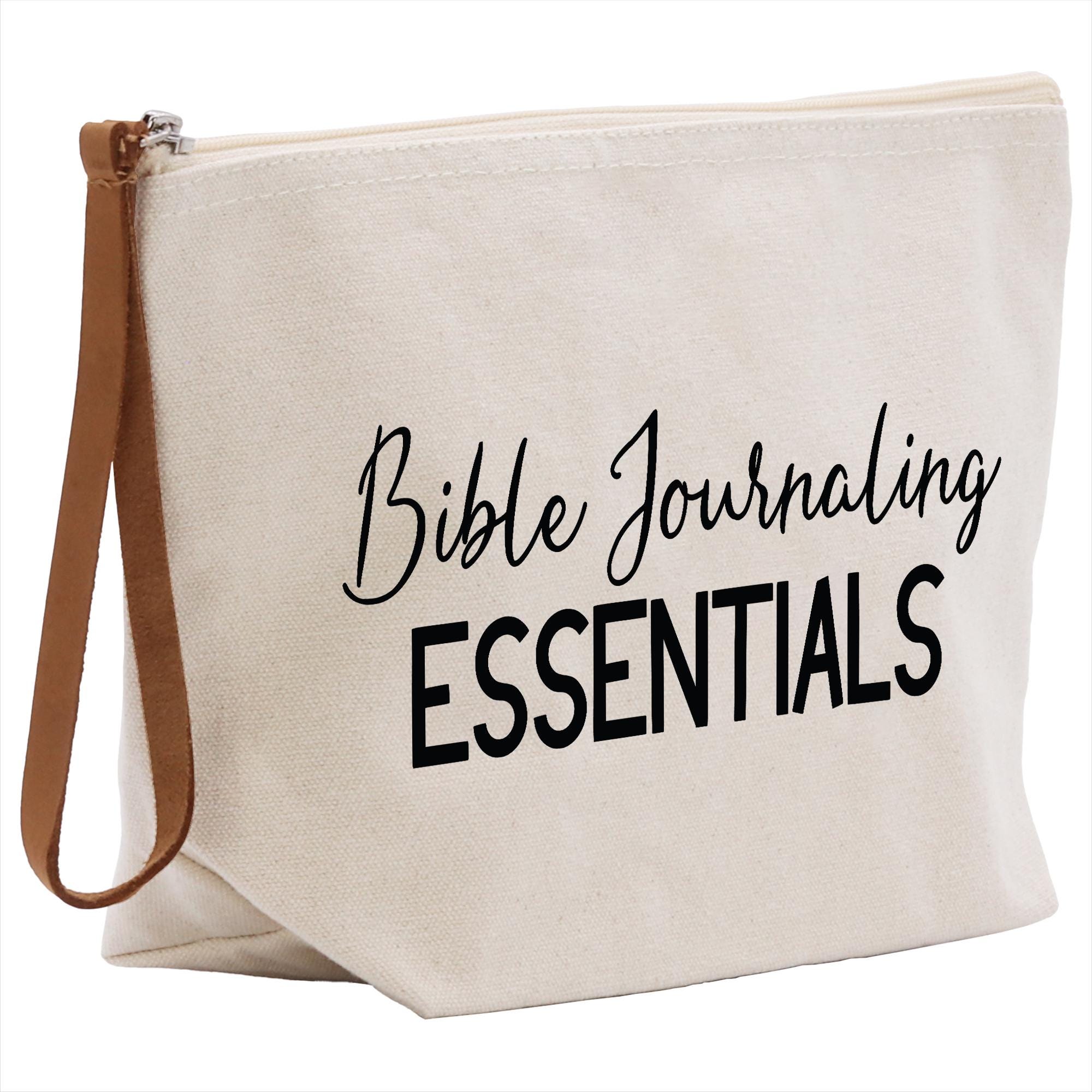 a white bag with black writing that says bible journaling essentials