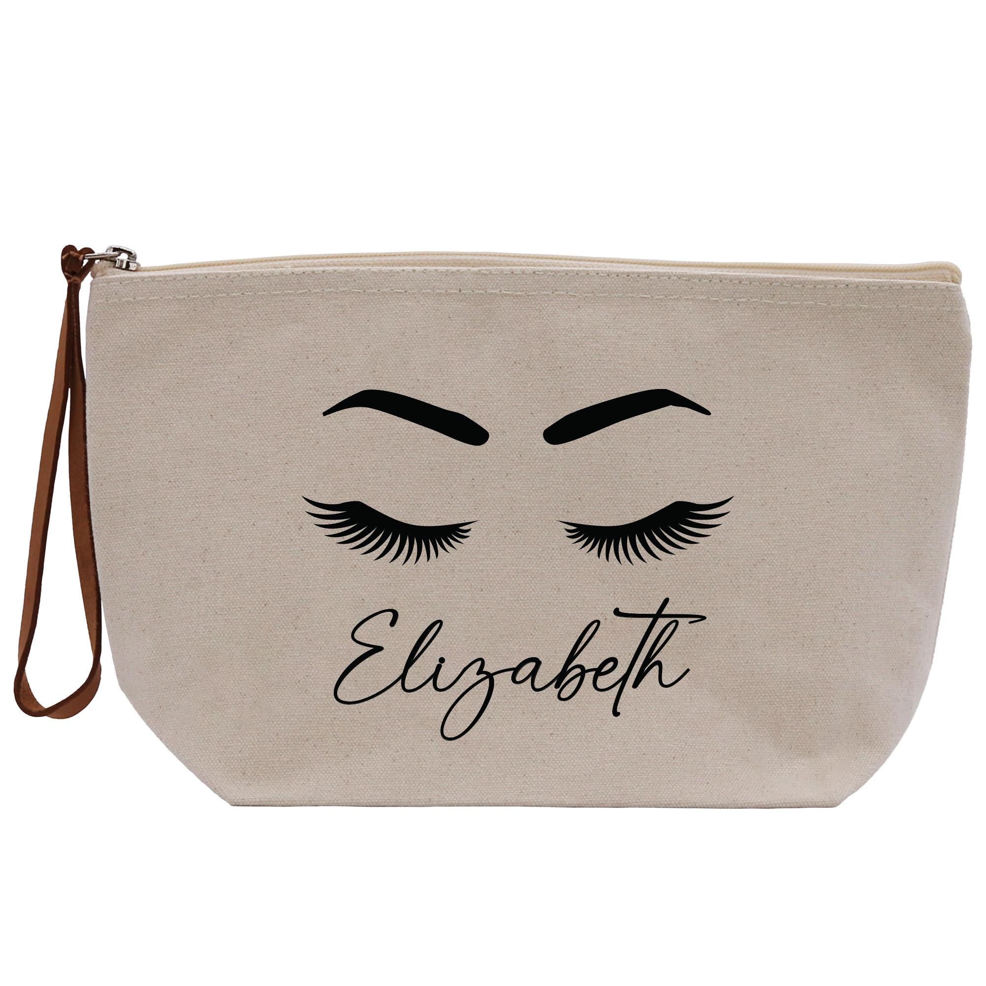 a white bag with eyelashes and the word elizabeth on it