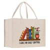 A beige tote bag with a printed design depicting a bookshelf with colorful books and a potted plant, accompanied by the text "I HAVE NO SHELF CONTROL".