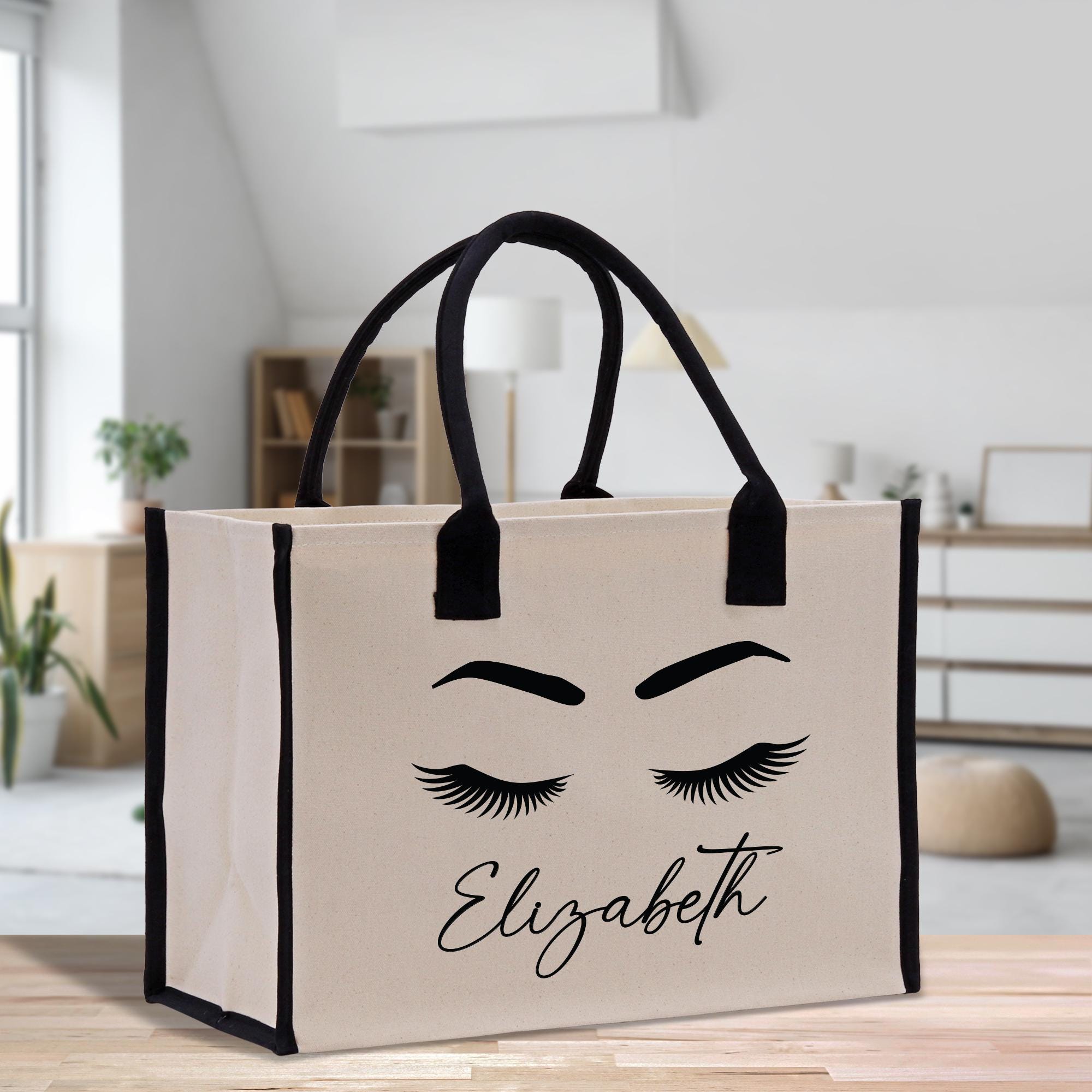 a shopping bag with eyelashes and eyelashes on it