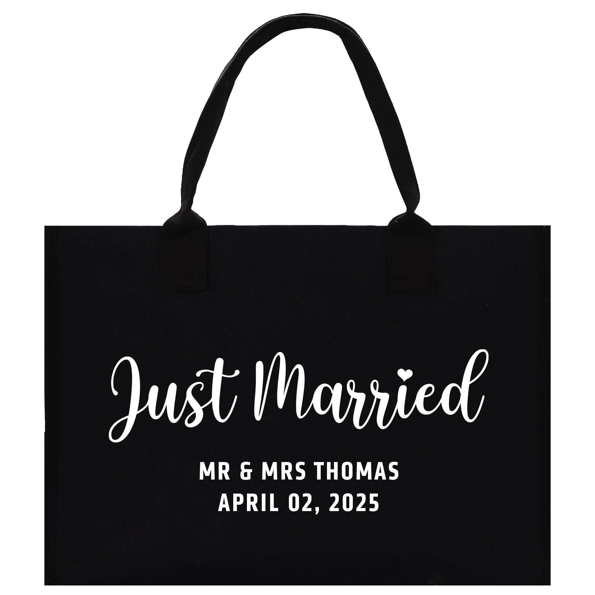 a black tote bag with the words just married printed on it