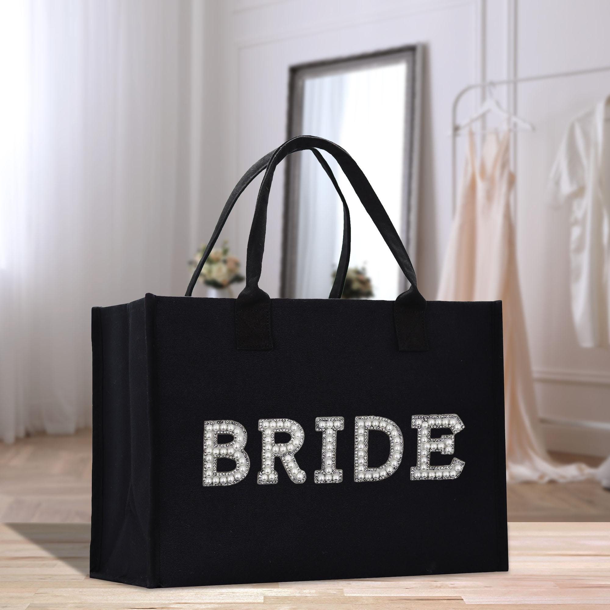 a black bride bag sitting on top of a wooden floor
