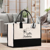 a black and white bag sitting on top of a wooden table