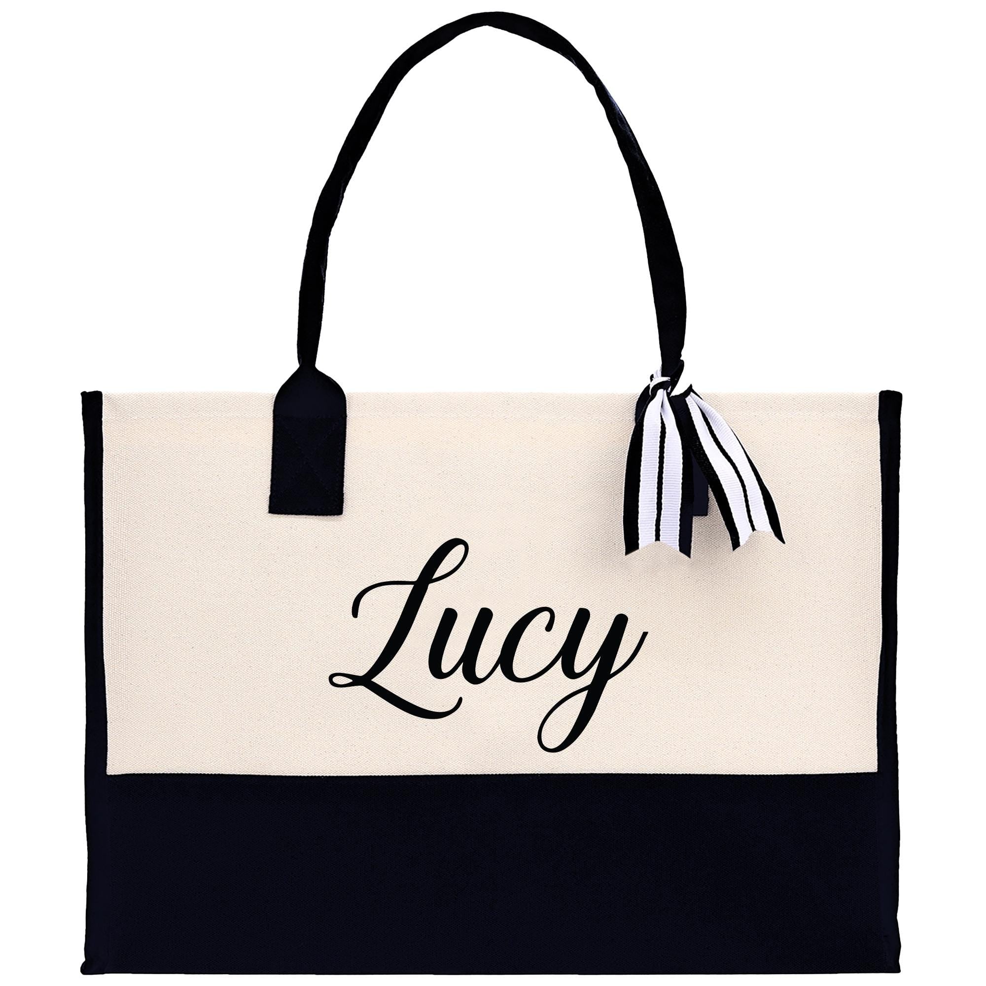 A black and white tote bag with the name &quot;Lucy&quot; printed on it in a cursive font.