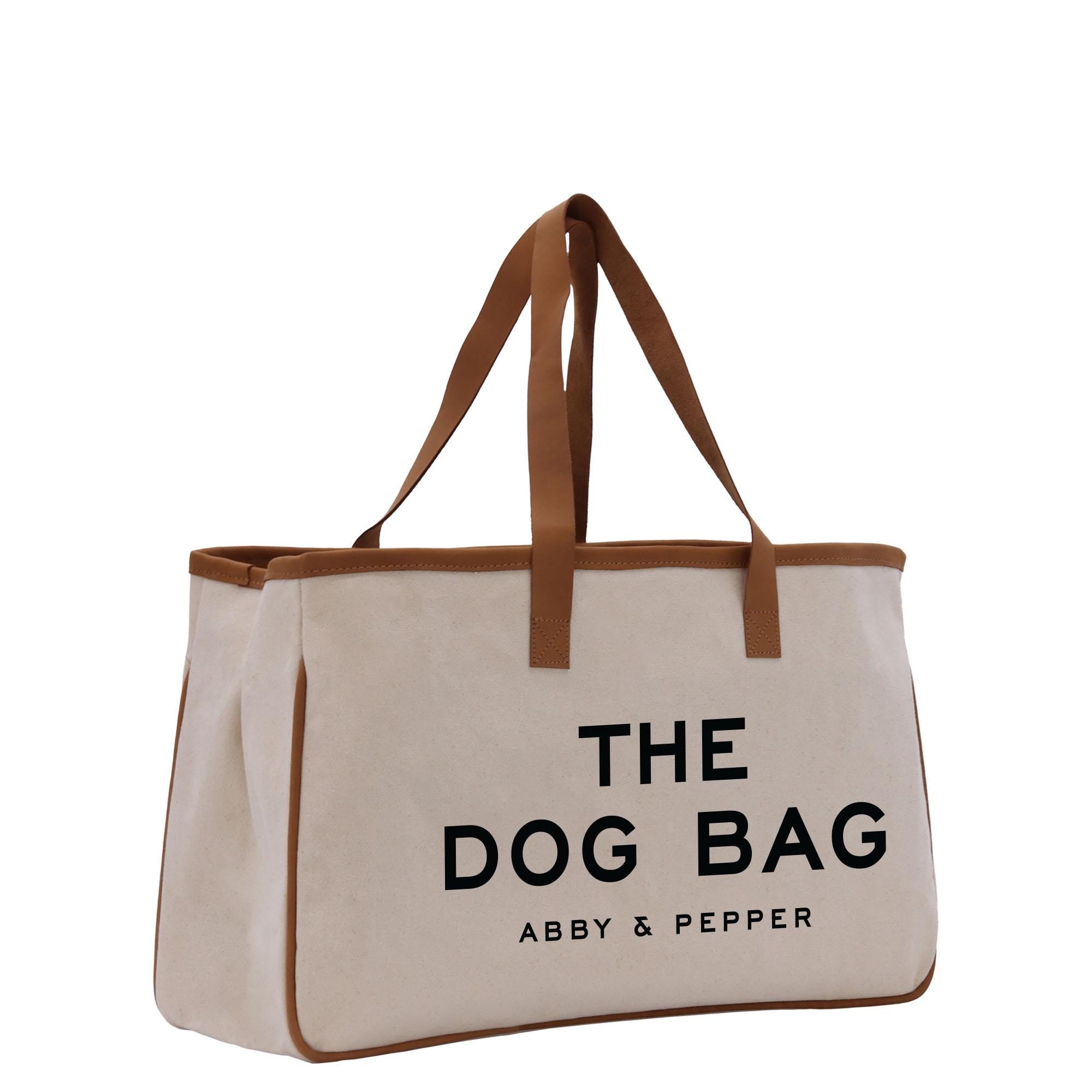 a white bag with a brown handle and the dog bag logo on it
