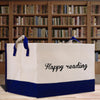 a white and blue shopping bag sitting on top of a wooden table