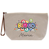 A beige canvas tote bag with a colorful graphic design featuring the word "BINGO" surrounded by various shapes and patterns, including stars, circles, and a burst effect.