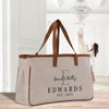 a white bag with a brown strap on a wooden floor