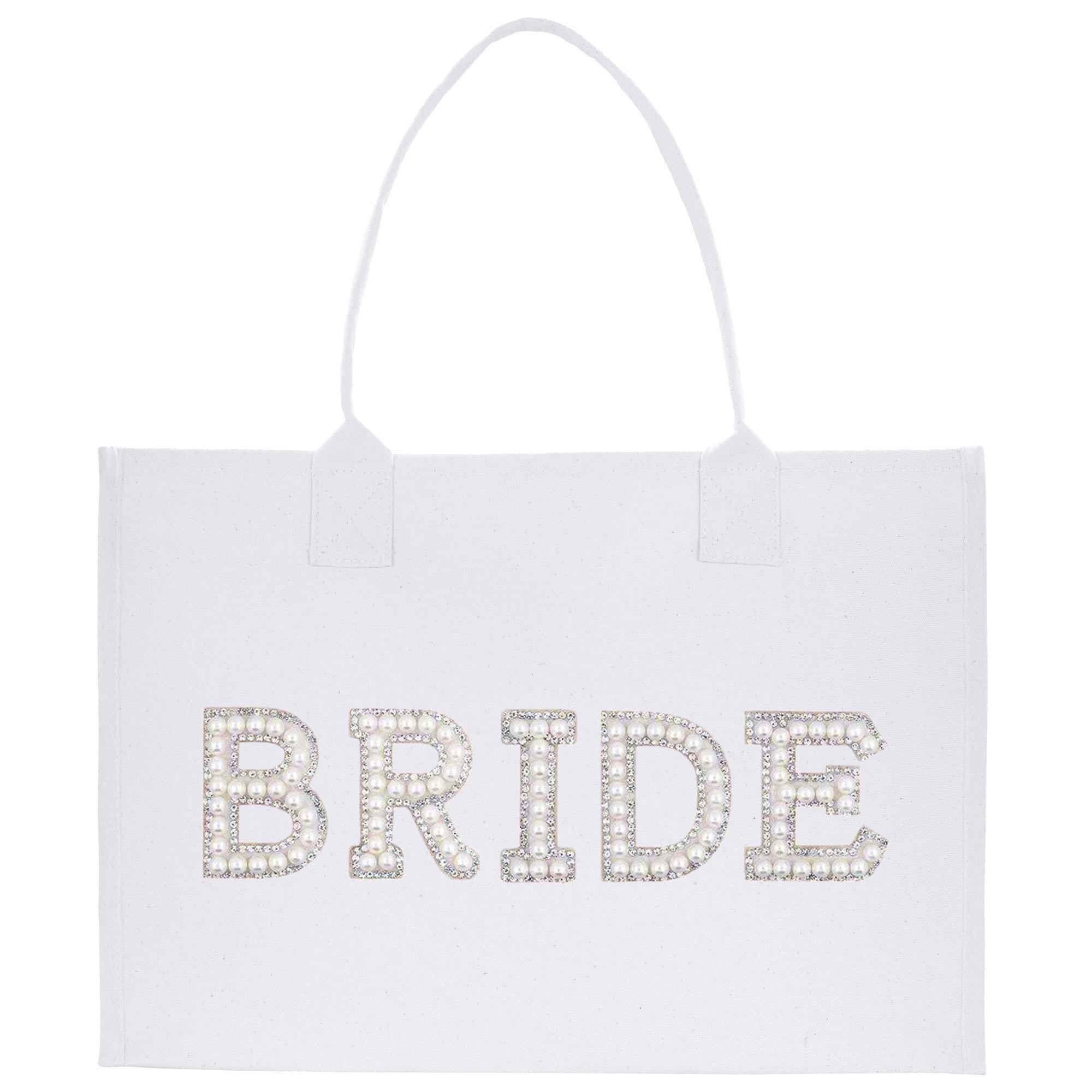 A white tote bag with the word &quot;BRIDE&quot; printed on it in large, glittery letters.