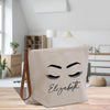 a canvas bag with eyelashes and the word elizabeth on it