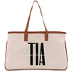 a canvas tote bag with a brown leather handle