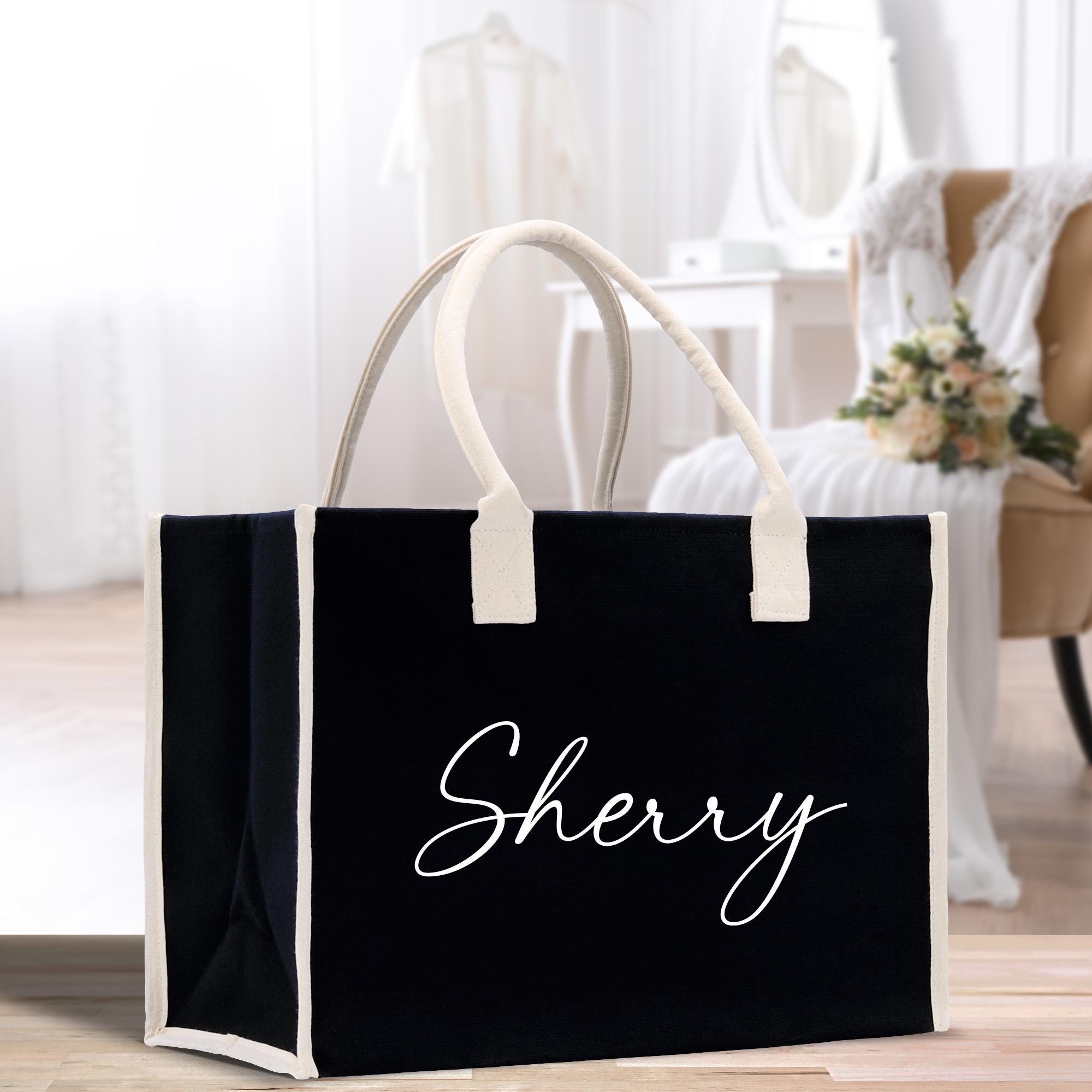 a black and white shopping bag with the word shery on it