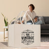 A white tote bag with a vintage-style design, featuring text that reads 